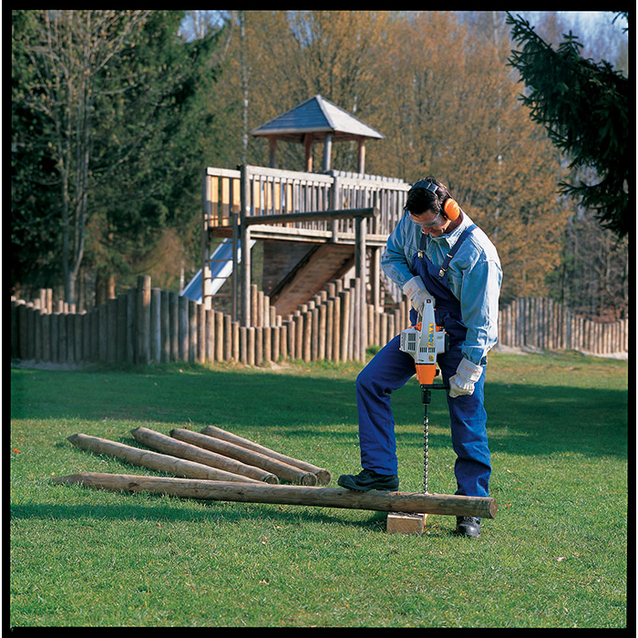 Man drilling into logs using the BT 45 Wood Boring Drill