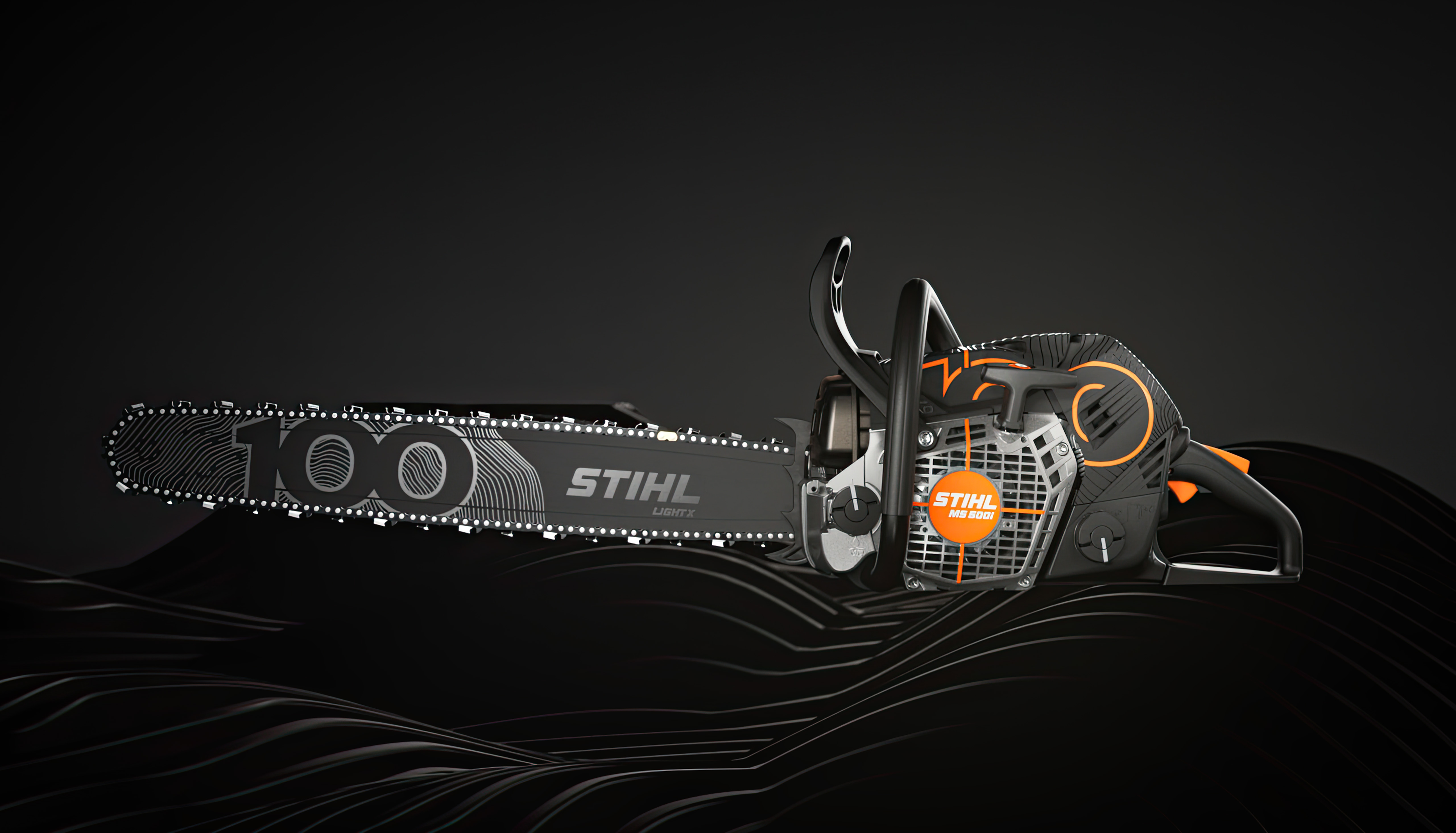 Side view of the STIHL MS 500i Centennial Edition chainsaw showing the black guide bar with 100 year anniversary graphics.