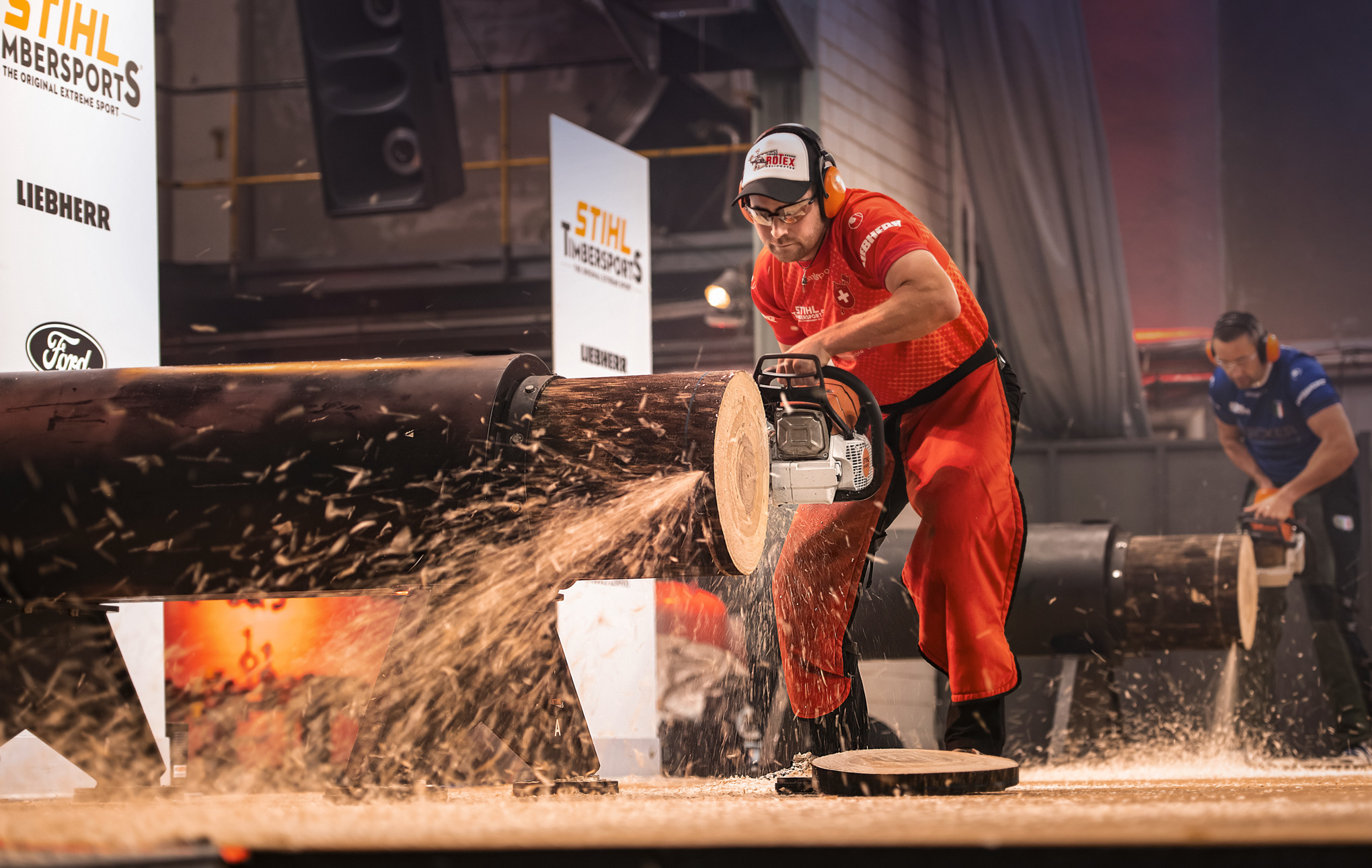 Man Competing in STIHL TIMBERSPORTS® Competition by Sawing Log