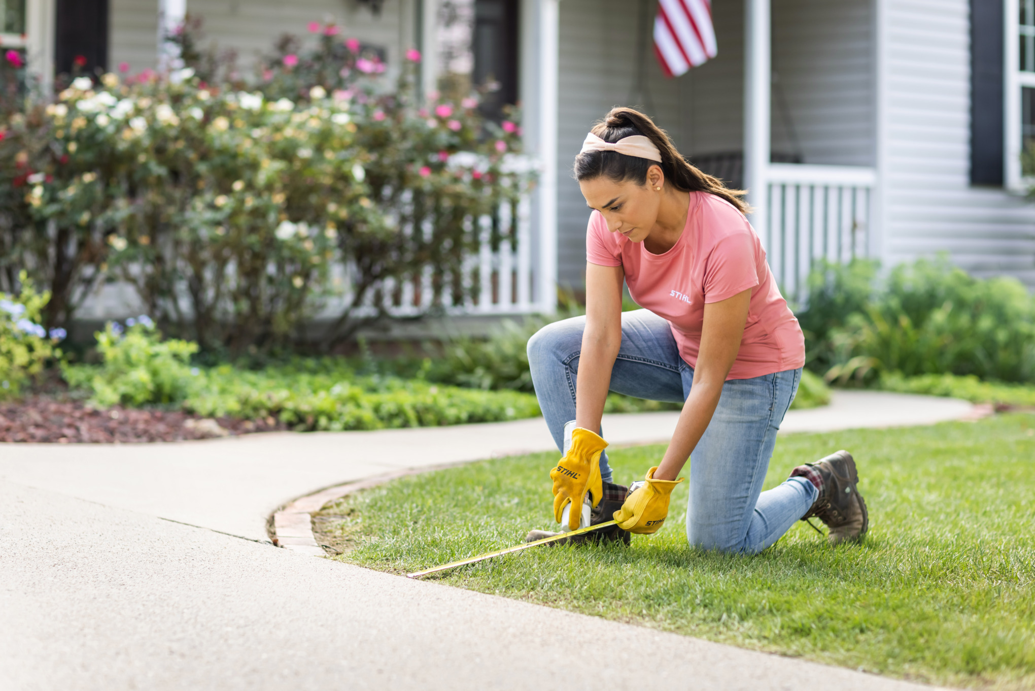 Sara Bendrick measuring out area for driveway pavers