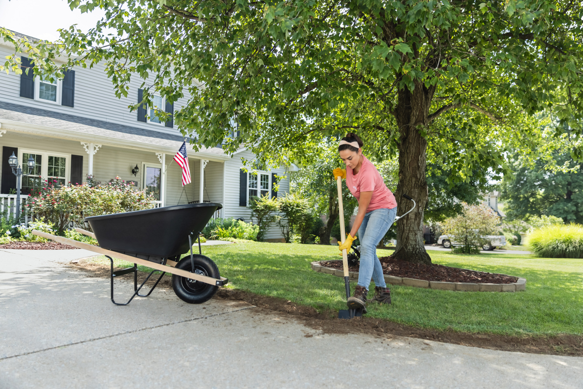 Sara Bendrick digging and leveling out excavated area.