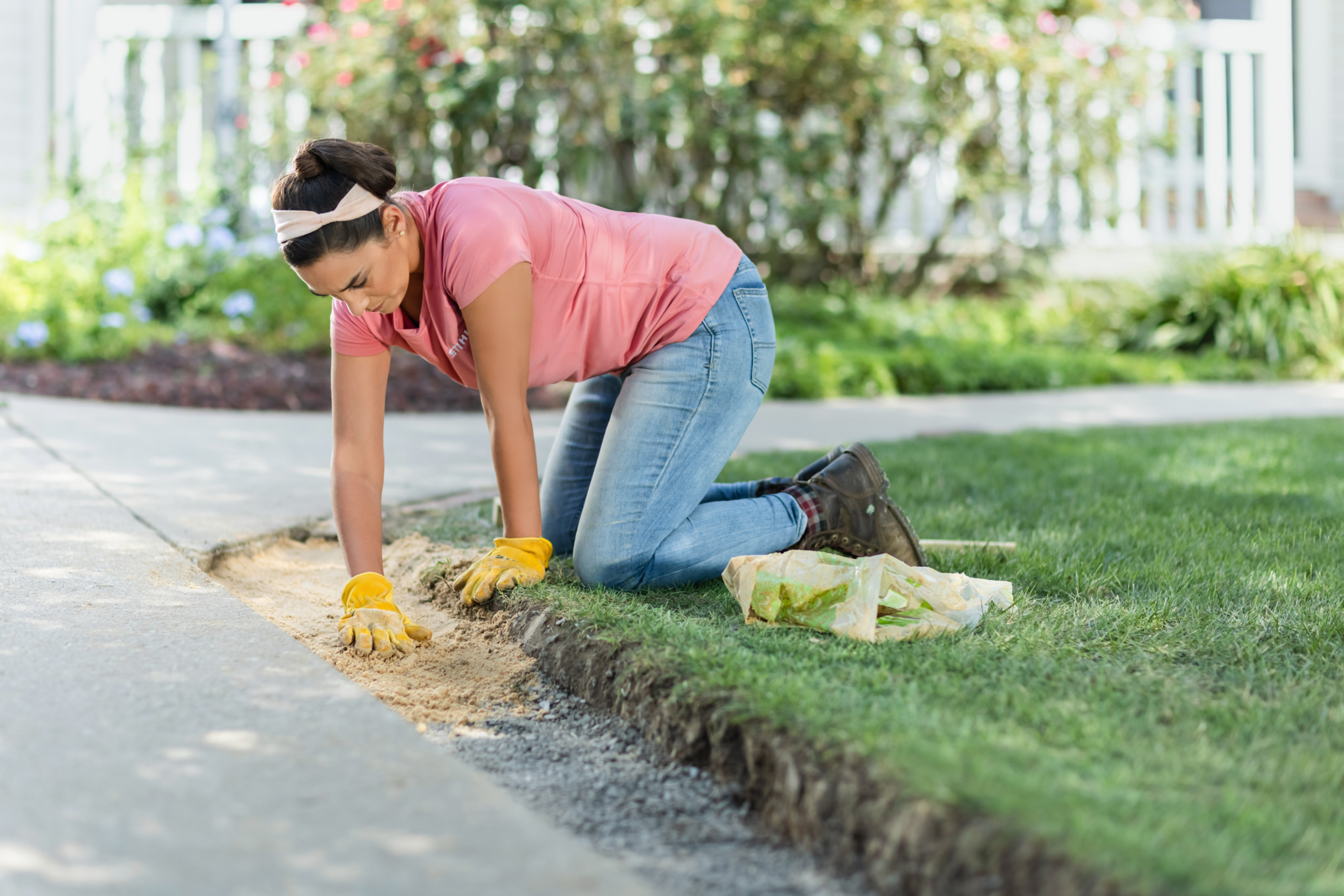 Sara Bendrick covering base gravel with masonry sand.