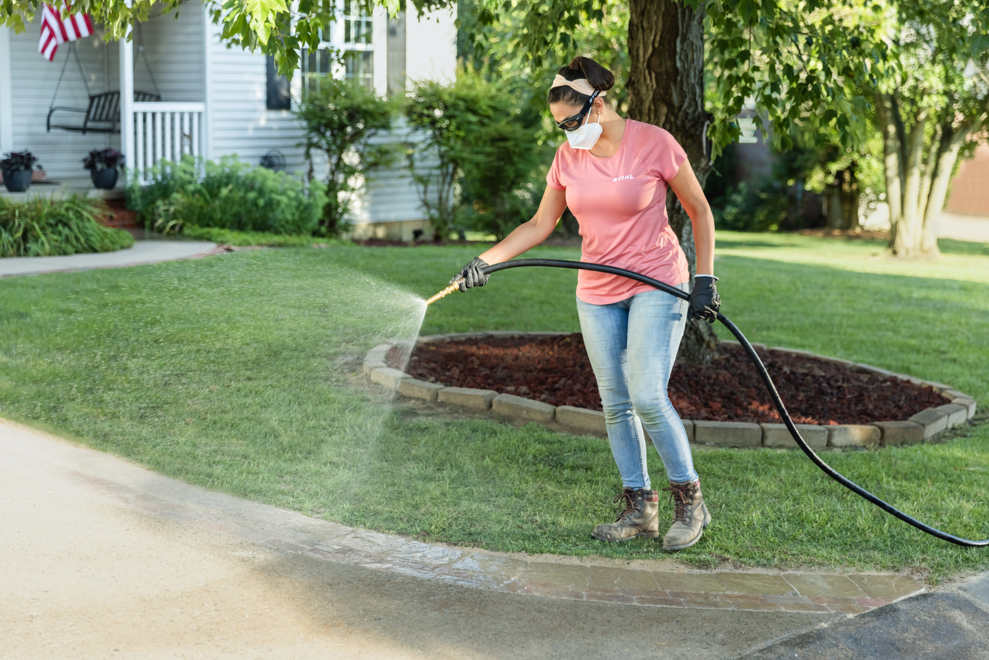 Sara Bendrick wetting down polymeric sand.