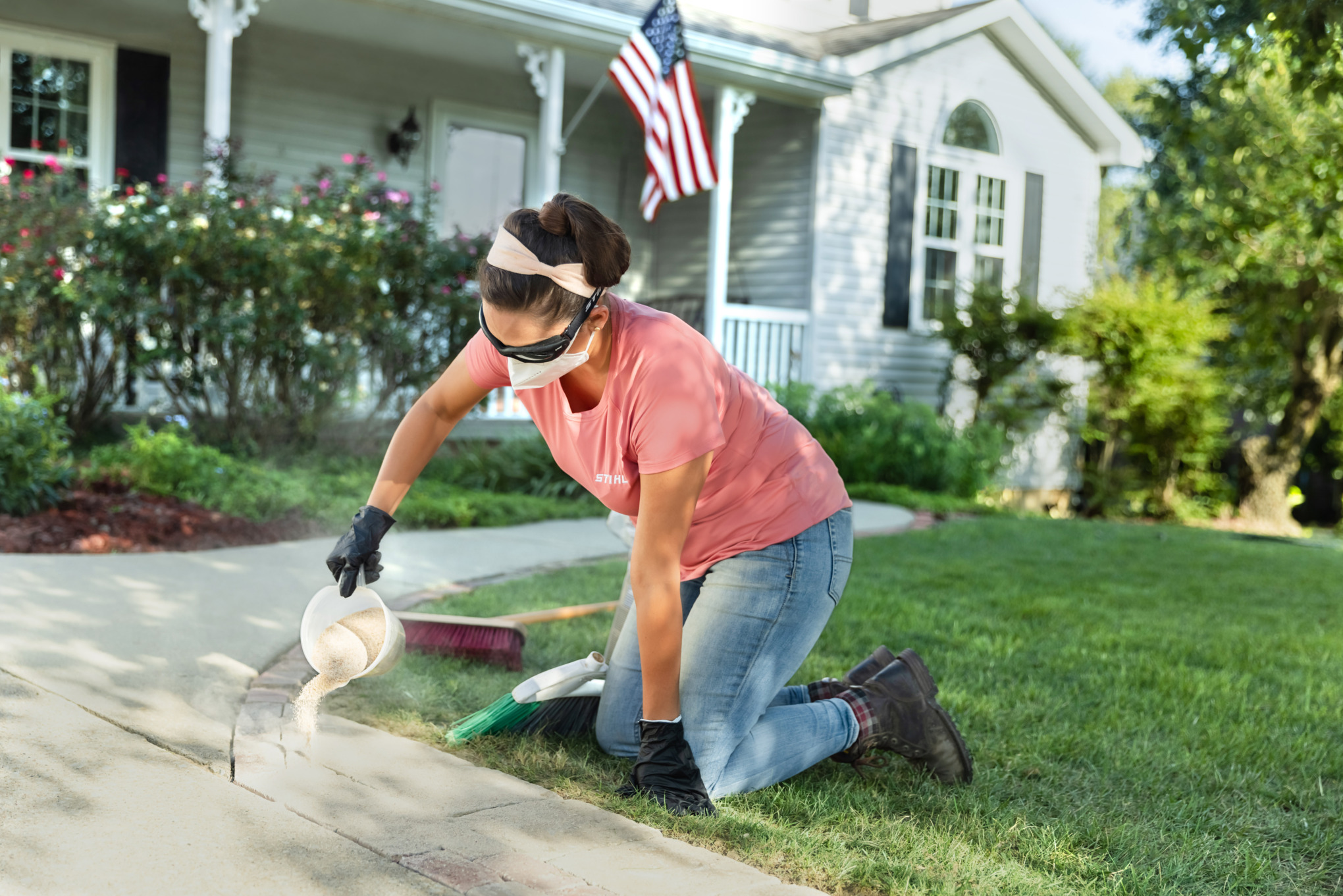 Sara Bendrick laying down polymeric sand.
