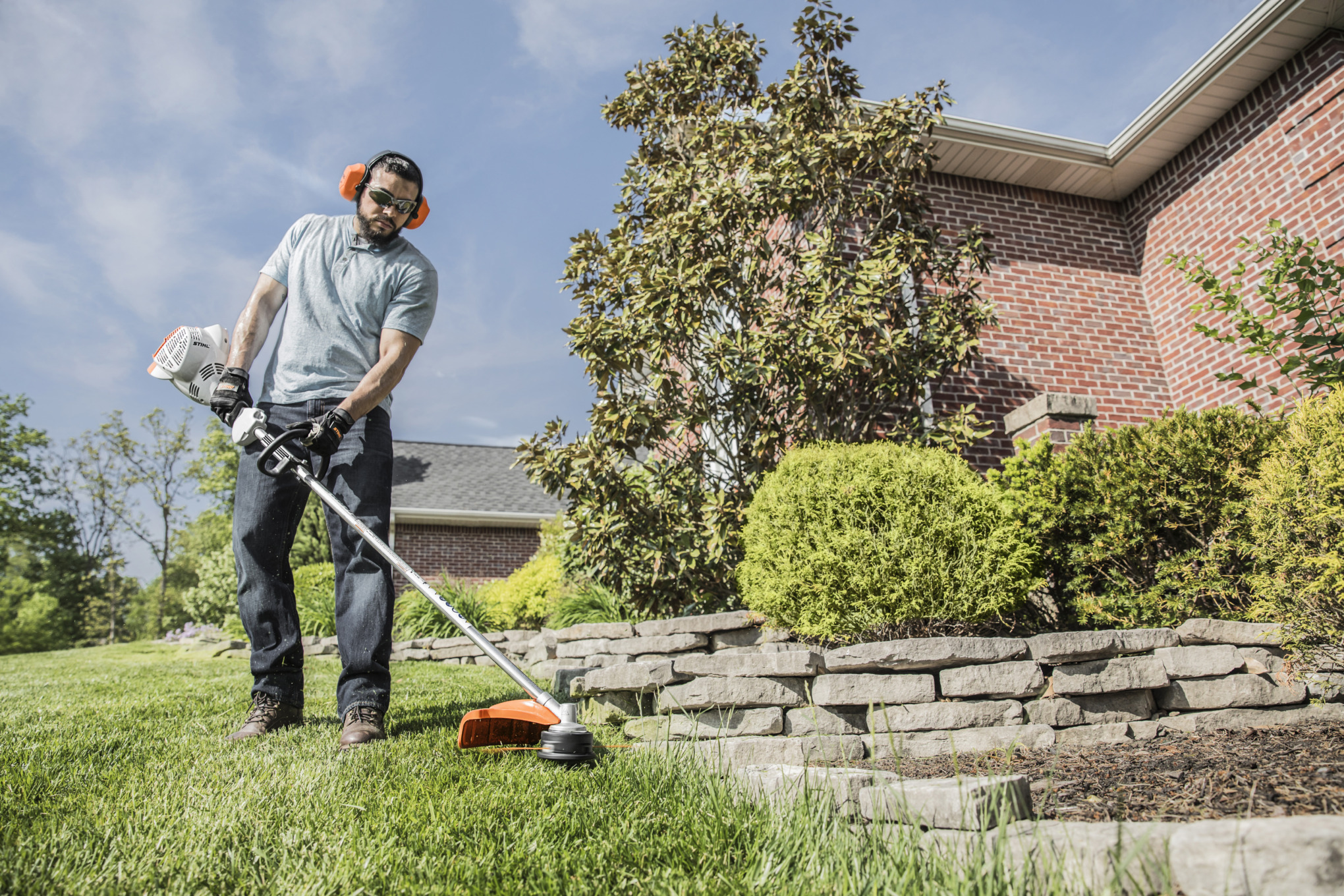 Man Using STIHL FS 56 RC-E to Trim Around Landscaping