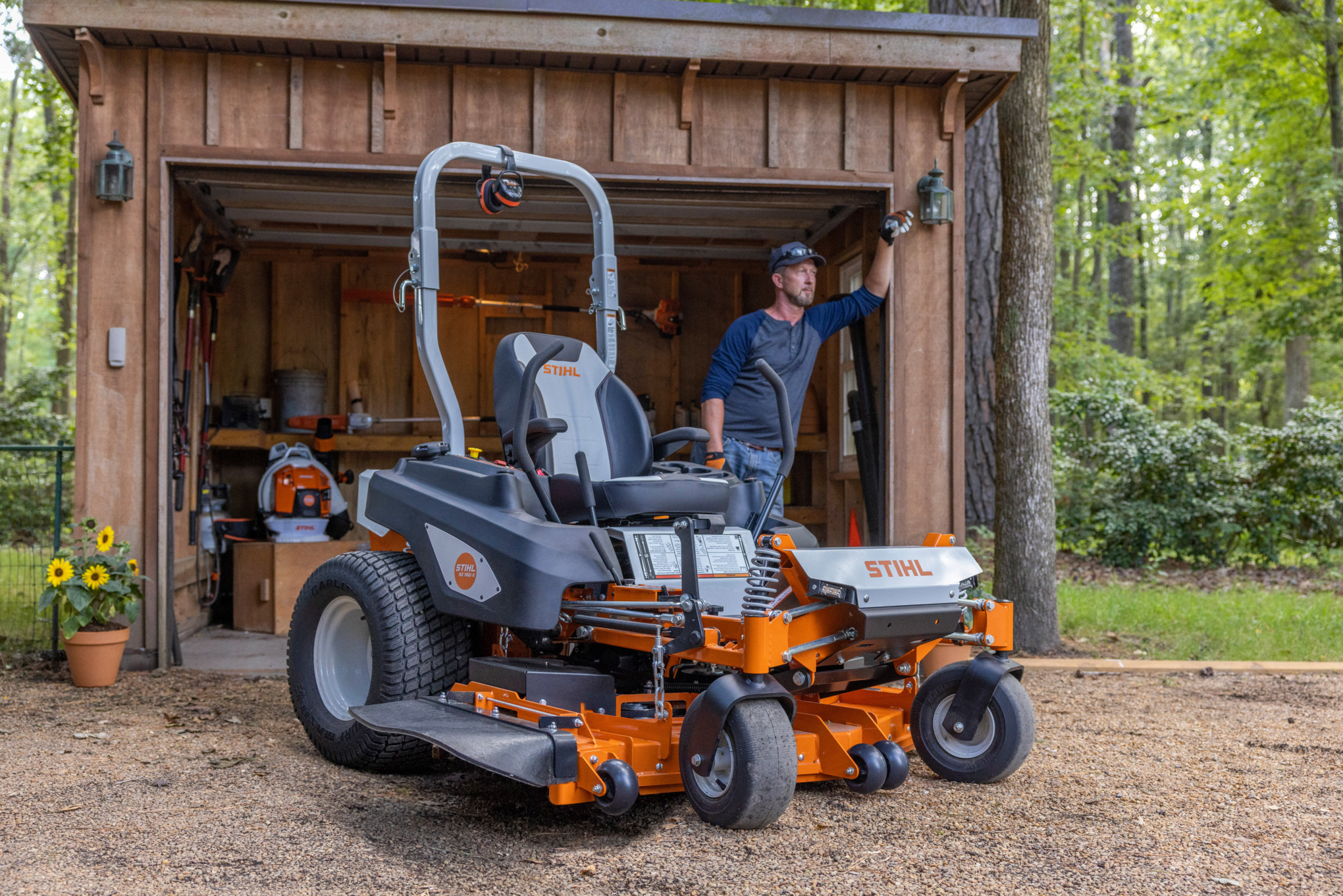 man standing near STIHL zero-turn mower