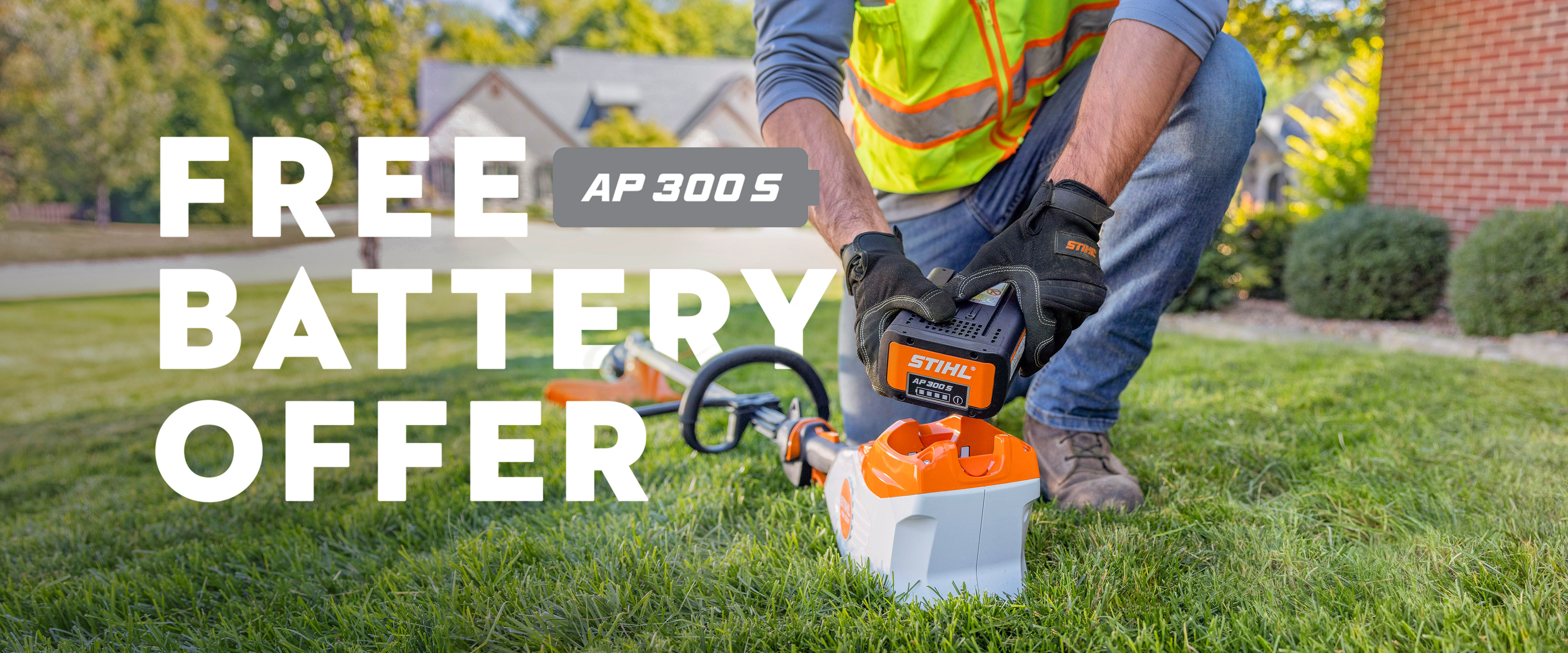 A person places a STIHL AP 300 S battery into a STIHL string trimmer on grass, alongside on‑image text promoting a free battery offer.
