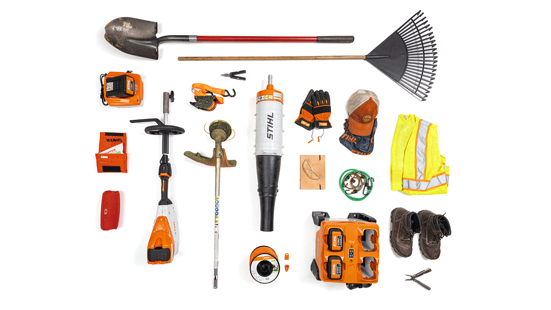 Knolling image of essential landscaper gear including STIHL kombisystem attachments and STIHL AP system batteries