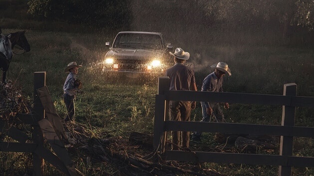 Family of ranchers work in the rain