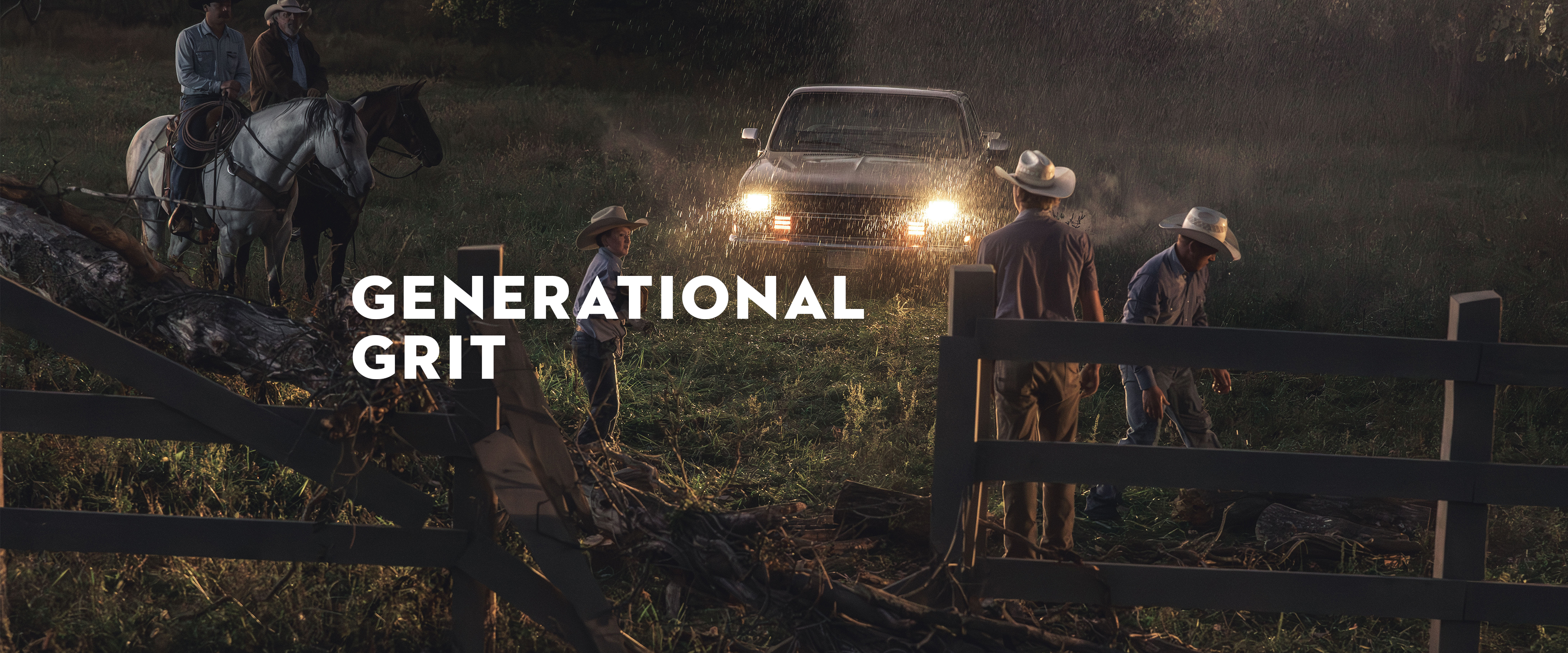 Family of ranchers working at night in the rain