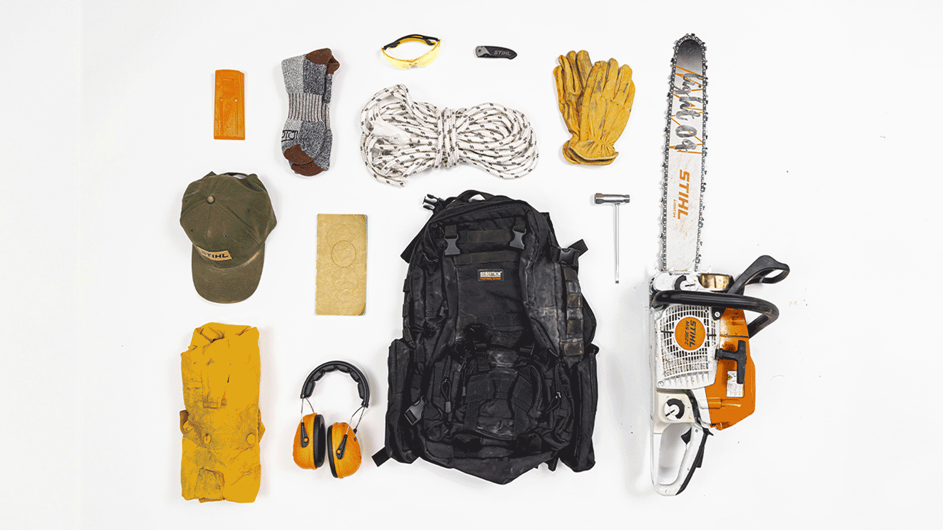 Knolling image of essential wildland firefighter gear including STIHL MS 362 C-M chainsaw
