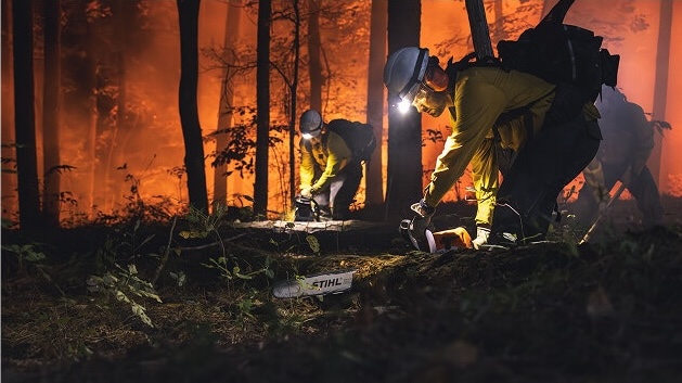 Wildland firefighters use STIHL chainsaw on fallen tree