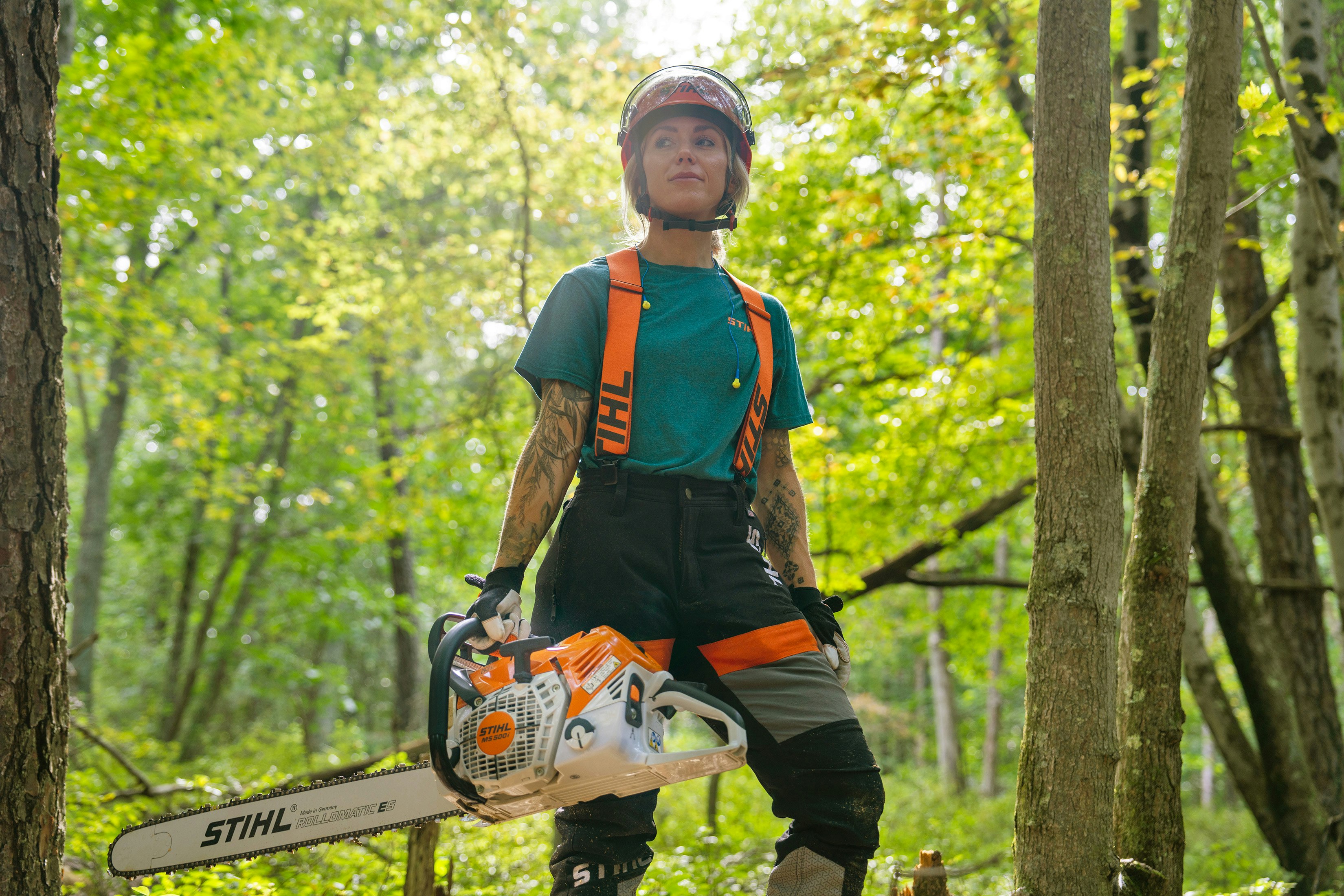 Katelyn Johnson in forest with STIHL MS 500i Chainsaw.