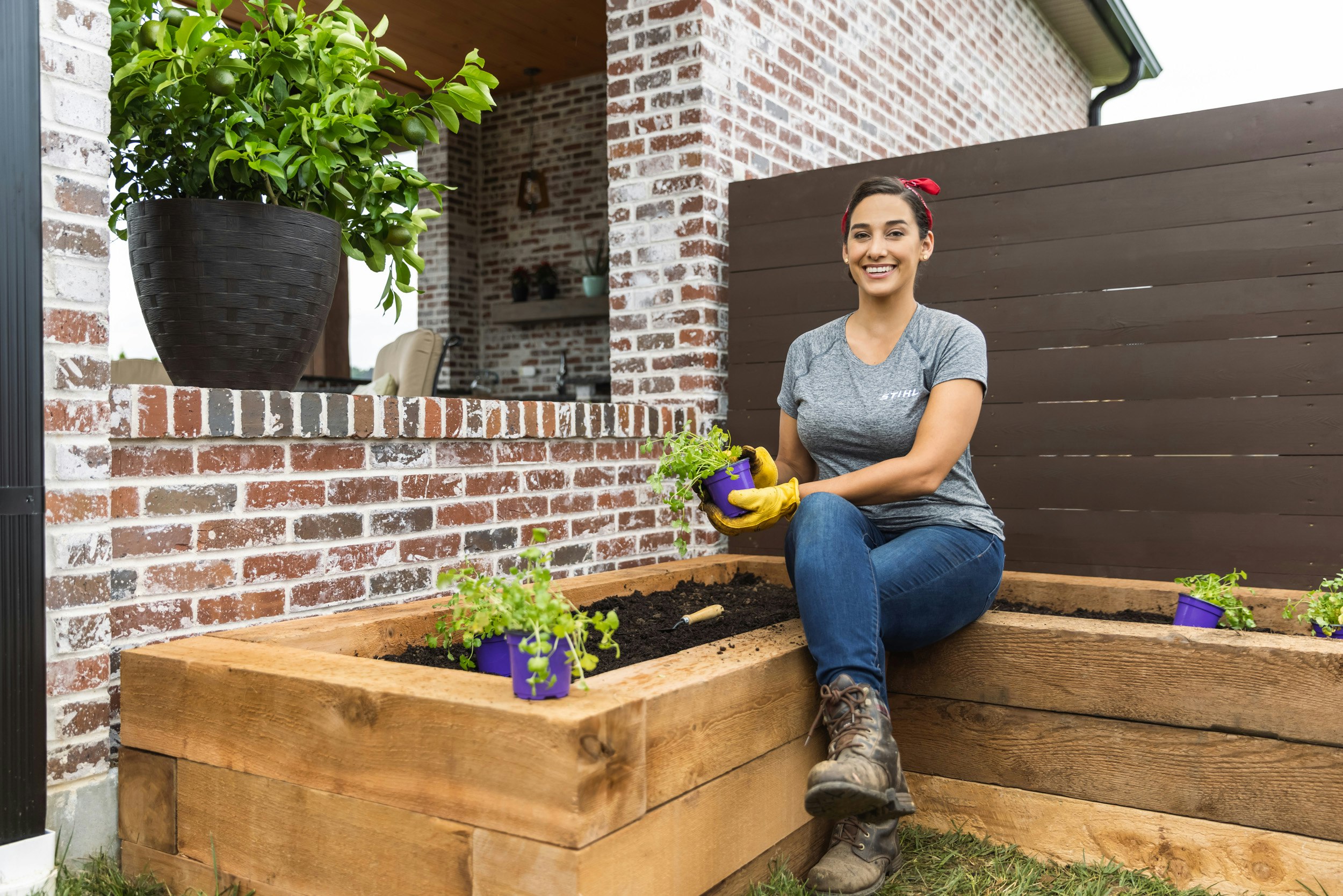 Sara Bendrick sitting next to salsa garden