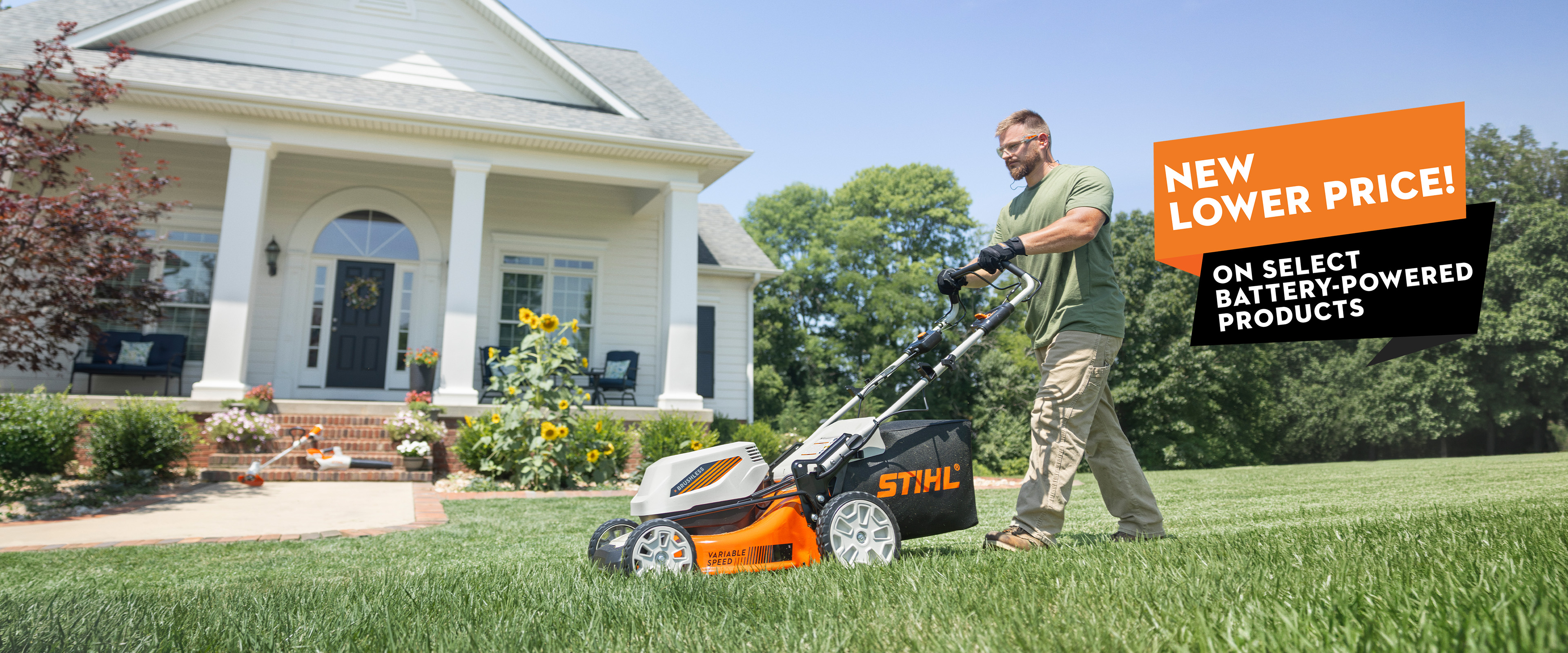 STIHL battery-powered push lawn mower being used on a residential lawn with promotional offer for select battery-powered products.