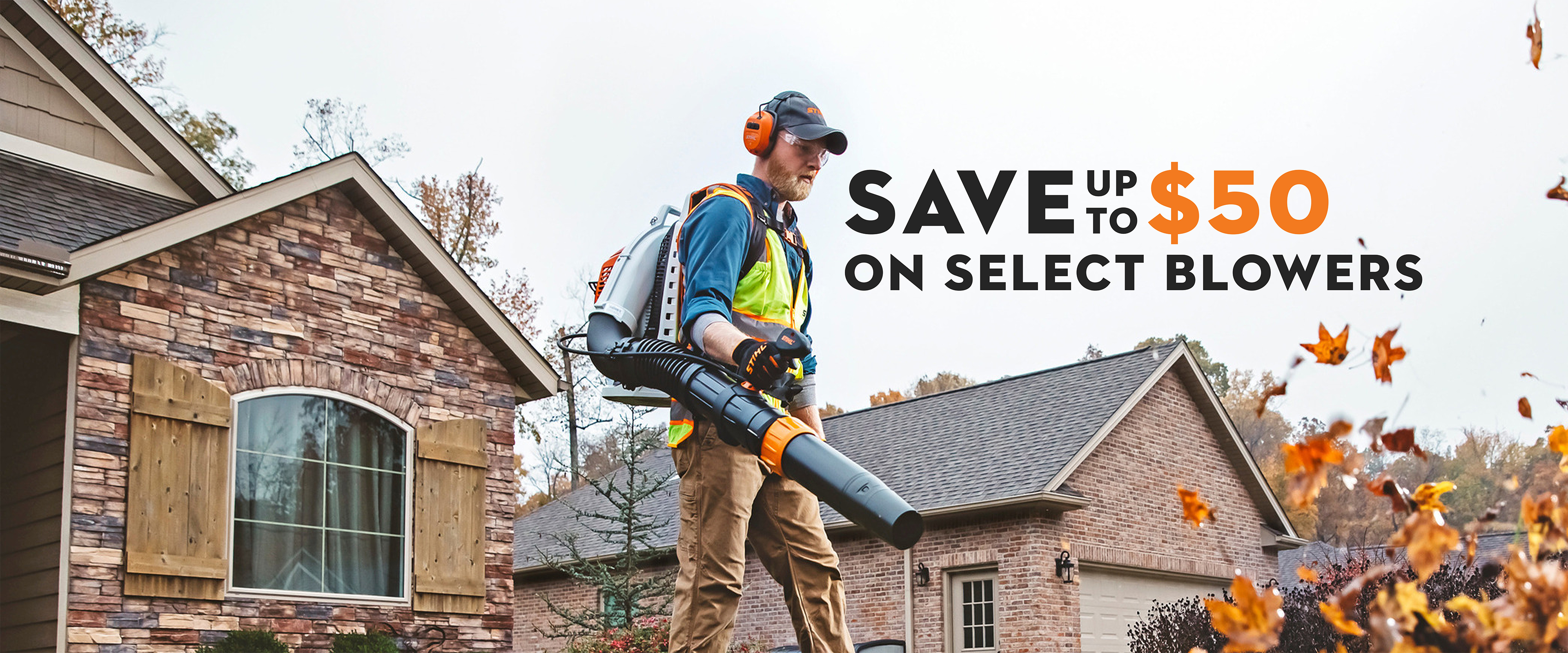 Landscape professional using a STIHL backpack blower to clear fallen leaves outside a residential home, with promotional text advertising up to $50 in savings on select blowers.