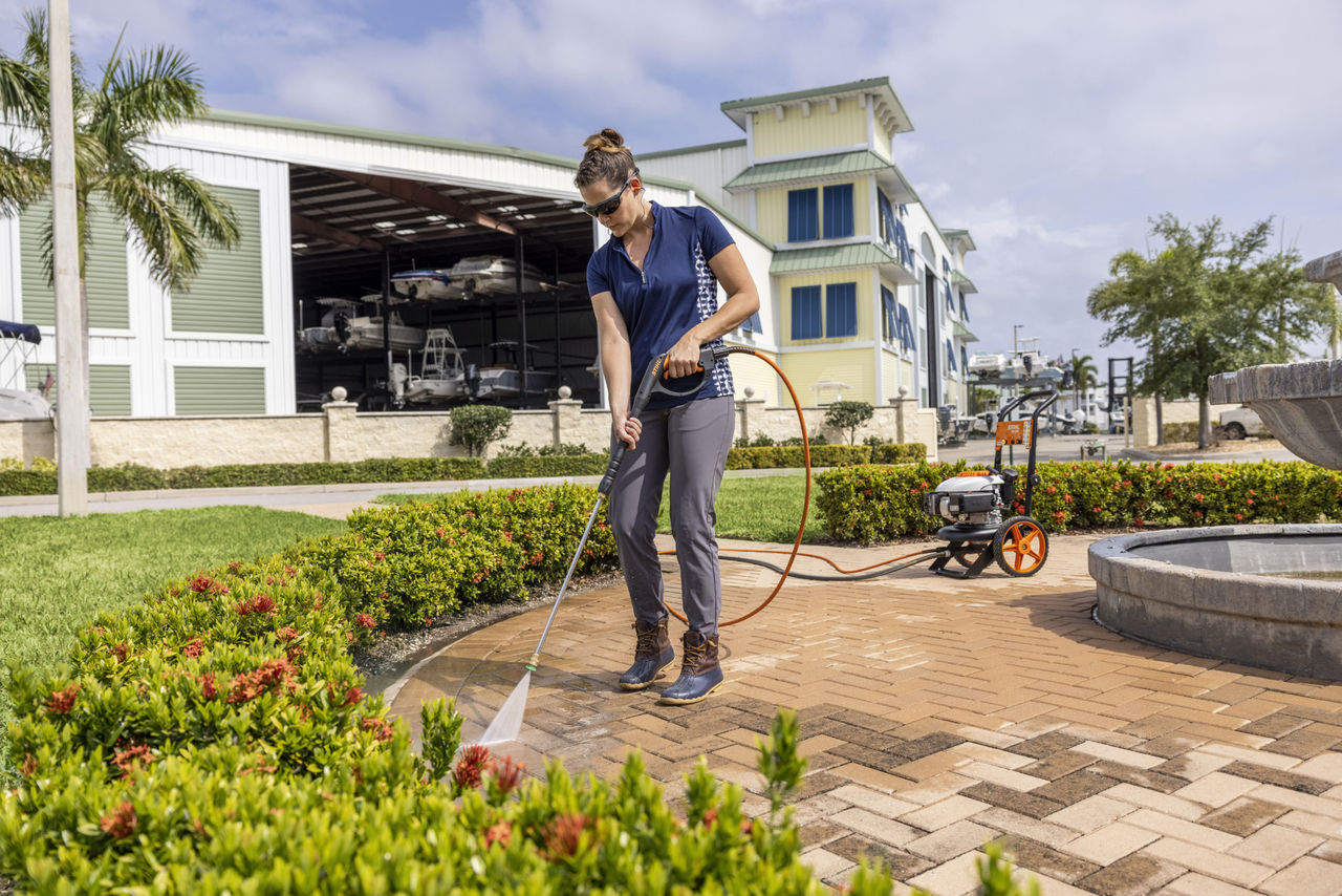 Woman Using STIHL RB 200 to Clean Patio