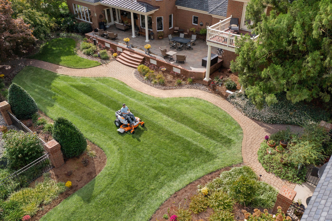 Man mowing stripes in yard with STIHL zero-turn mower