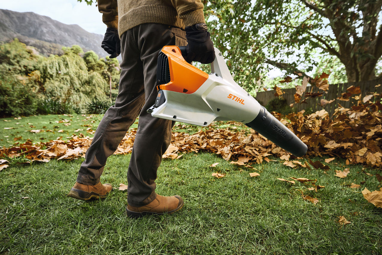 STIHL Blower Clearing Leaves in Backyard