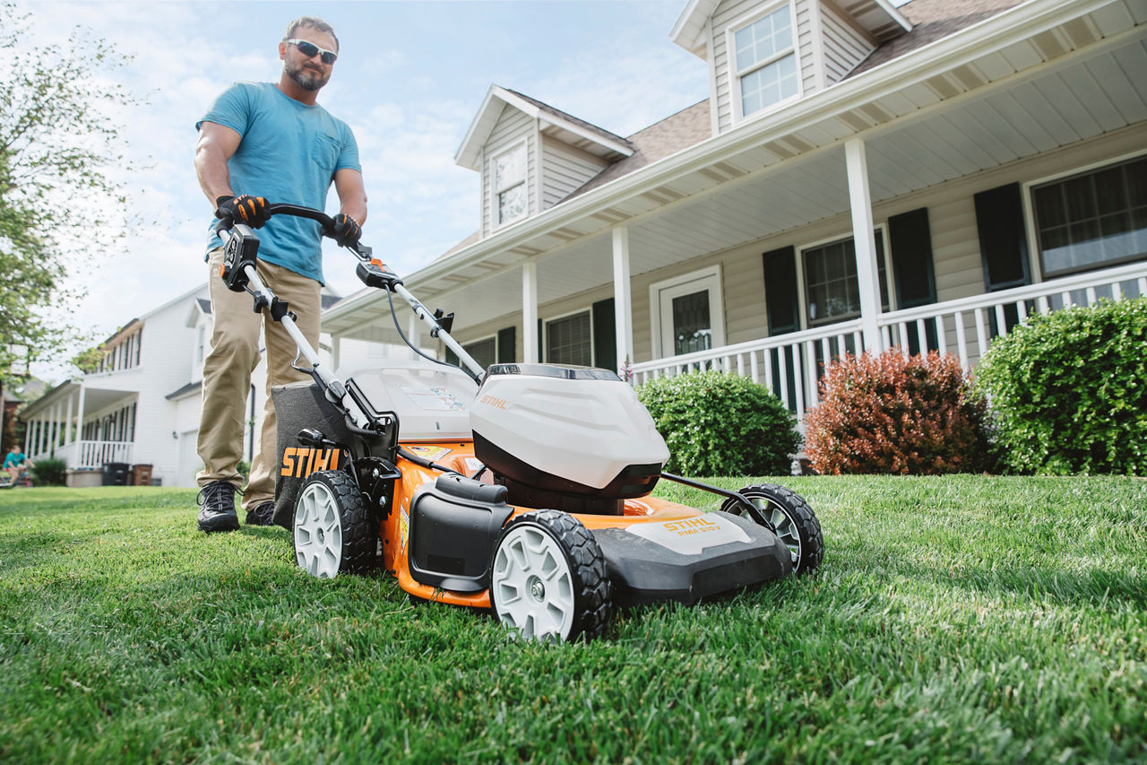 Man Mowing Front Yard with STIHL Push Mower