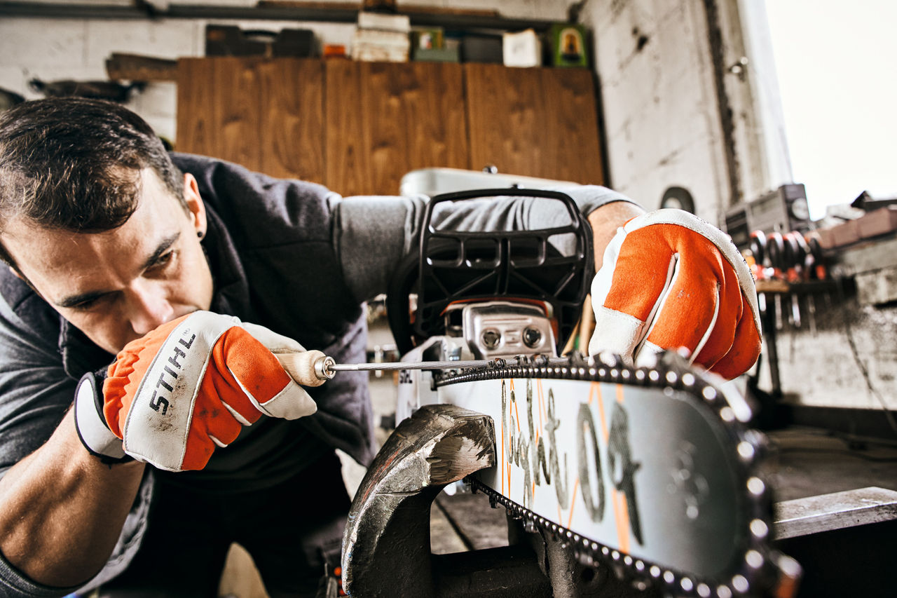 Man Sharpening His STIHL Chainsaw