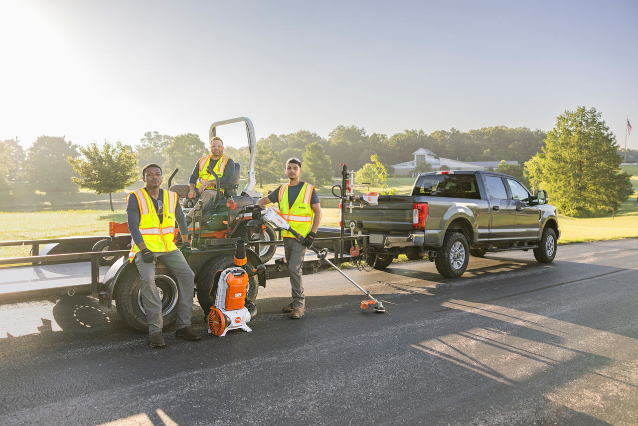 Three Landscapers Standing with Truck and Landscpaing Trailer of STIHL Products