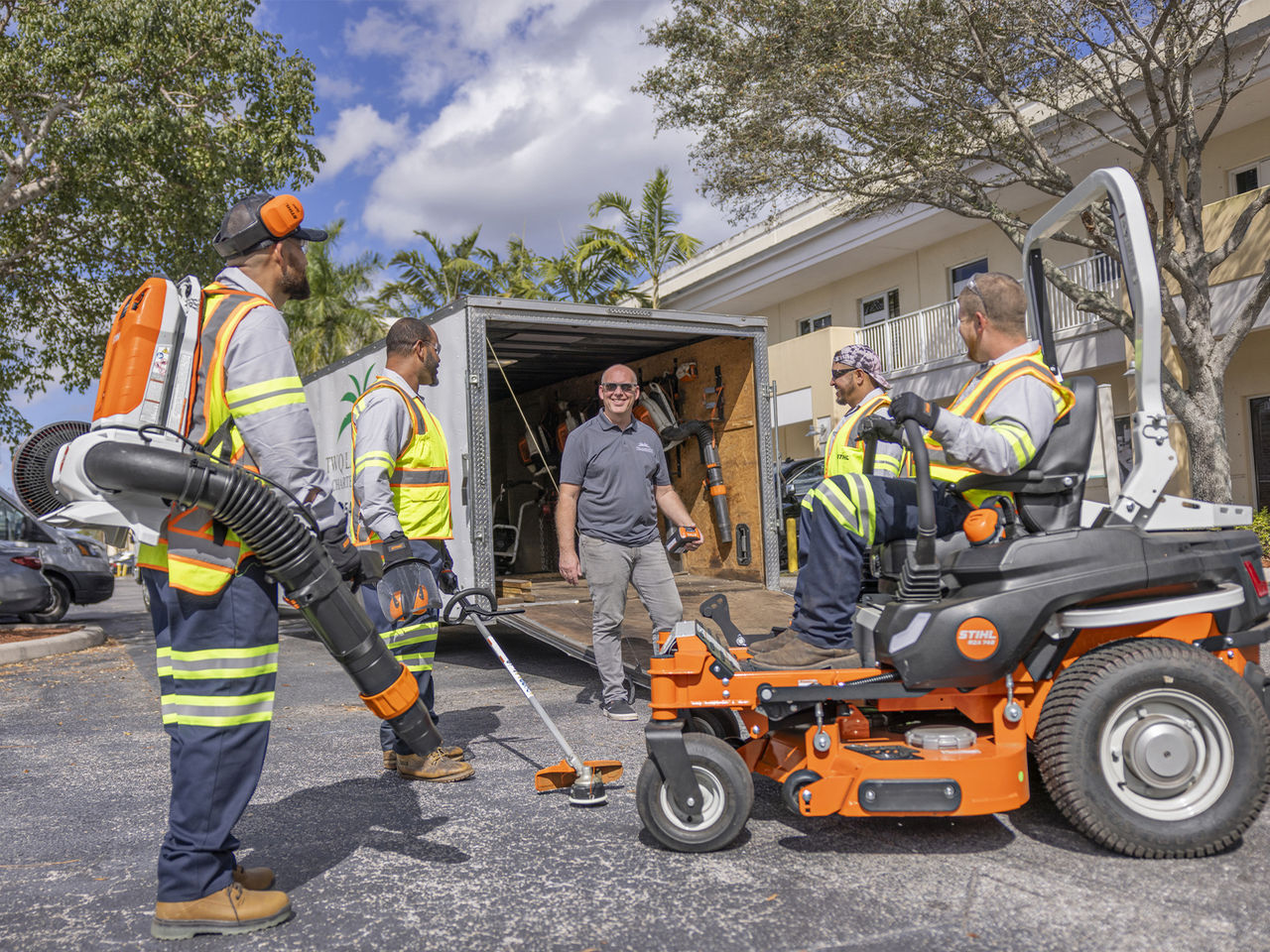 Professional crew testing STIHL commercial landscape equipment during an on-site equipment demonstration