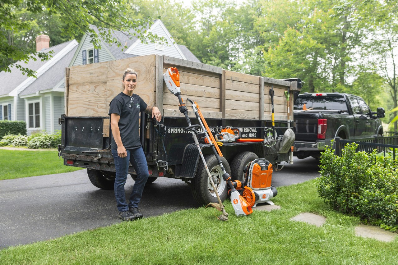 Landscape Business Owner Ashley Buckley Standing in Front of Trailer Full of STIHl Tools
