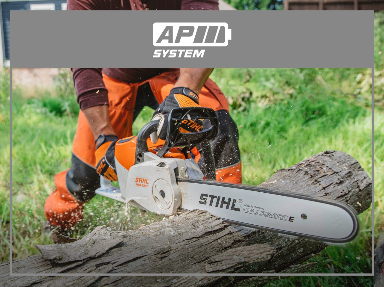 STIHL AP System battery-powered chainsaw cutting a large log outdoors